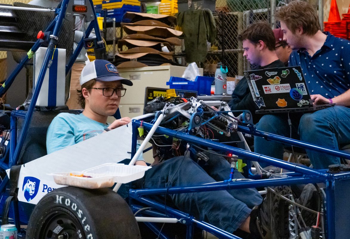 Nittany Motorsports low voltage subsystem team members work late at night developing and troubleshooting code for vehicle modules.