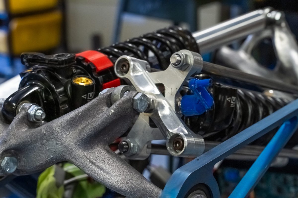 Front suspension on the Nittany Motorsports FSAE car. Aside from fasteners, ball joints, shock absorbers, and springs, all suspension components are conceptualized, designed, and produced by students on the team.